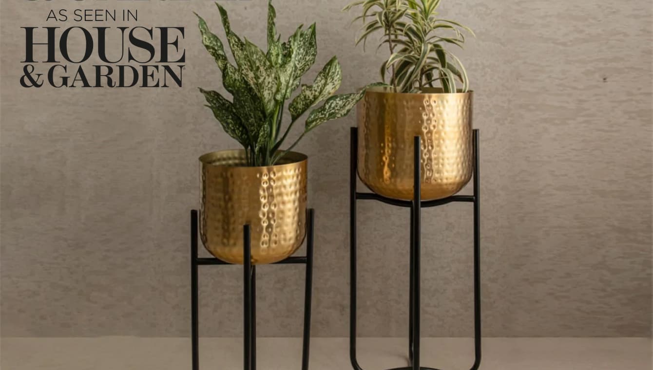 Set of 2 standing golden planters on black stand. Featured in house & garden text overlay
